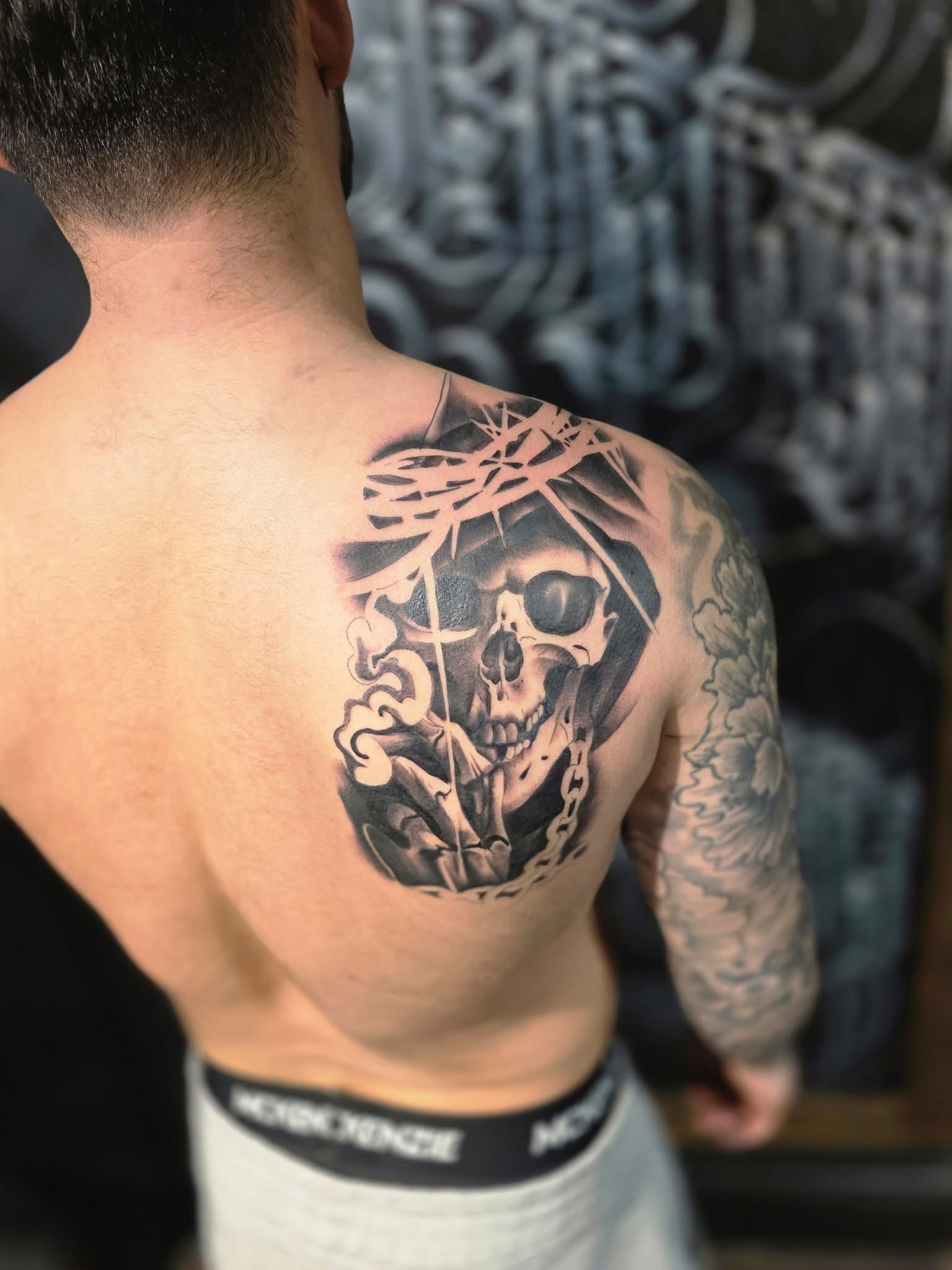 Black and grey shoulder tattoo by Michael Lisney