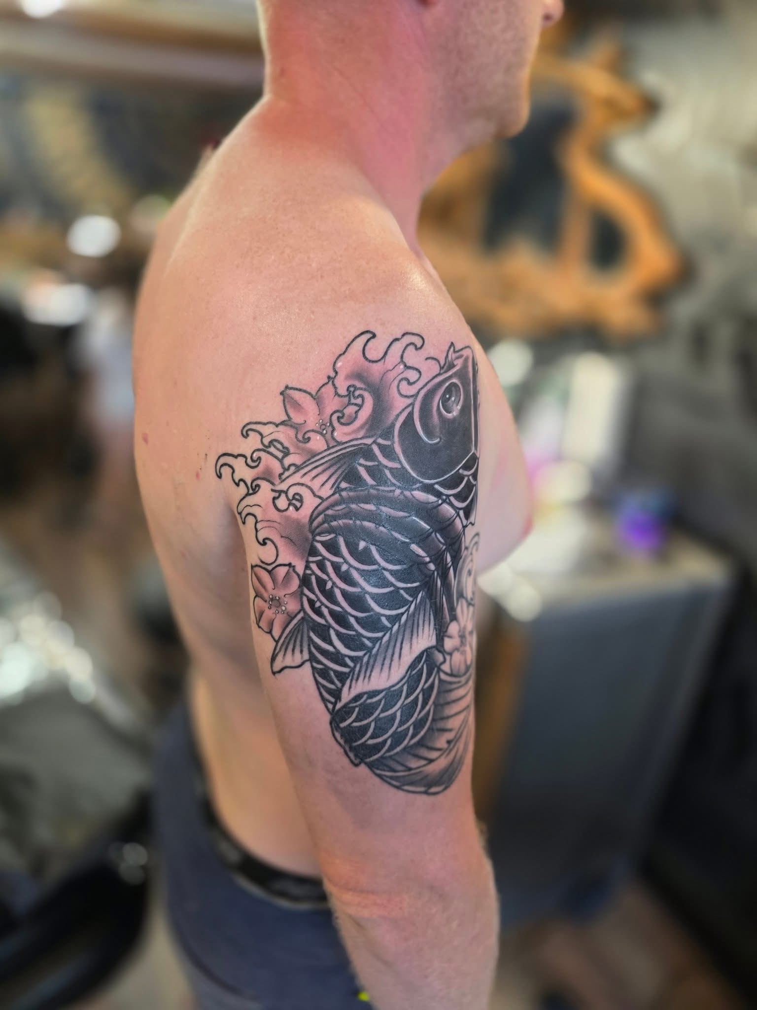 Upper arm blackwork tattoo by Michael Lisney