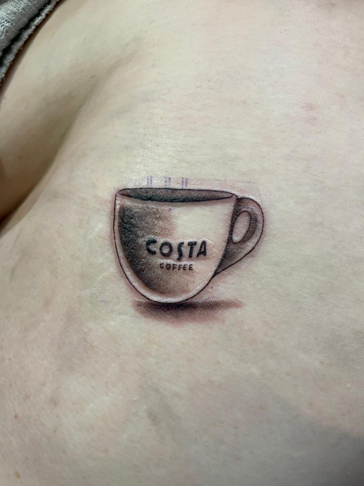 Micro realism coffee cup tattoo by Michael Lisney